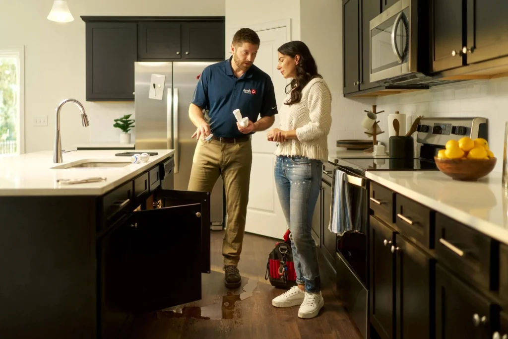 Licensed plumber explaining a plumbing repair to a homeowner in Denver
