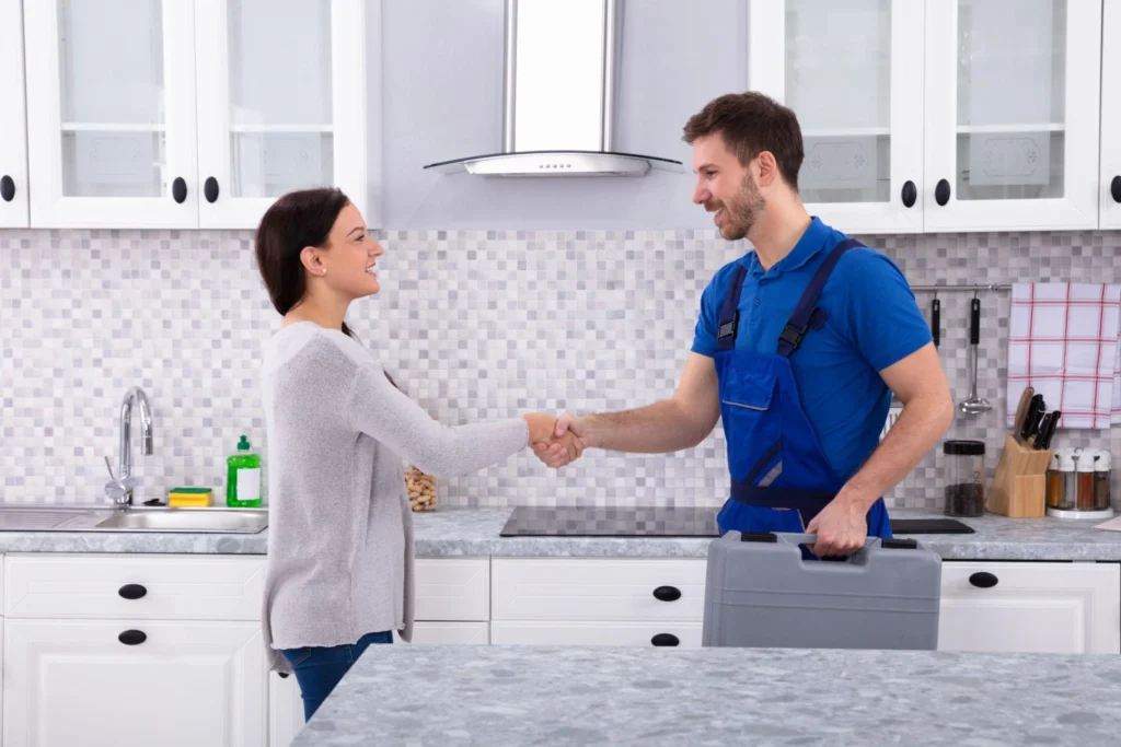 Happy homeowner with a professional Denver plumber after a successful plumbing repair