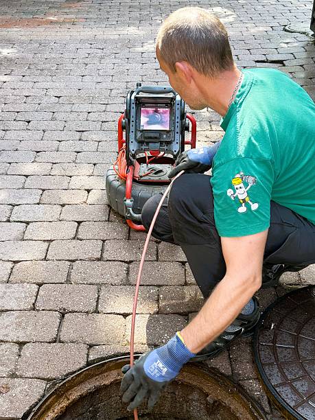 Plumber performing a sewer camera inspection in Brighton, CO
